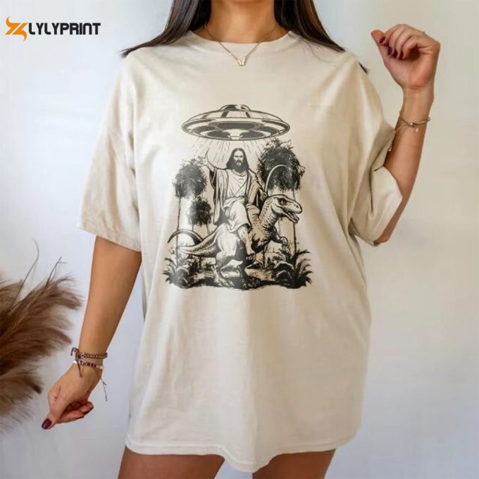 Jesus Riding Dinosaur Ufo Tee - Quirky Sci-Fi Inspired T-Shirt - Unique Fantasy Graphic Tee 1